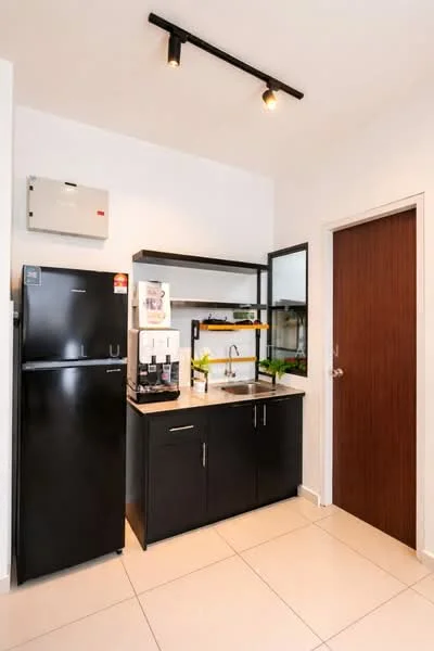 Kitchen features: black refrigerator, black cabinetry, granite countertop, single-bowl stainless-steel sink, chrome pull-down faucet, mirror backsplash, under-cabinet lighting, tile flooring, wall-mounted electrical panel, door to adjacent room; style: modern.