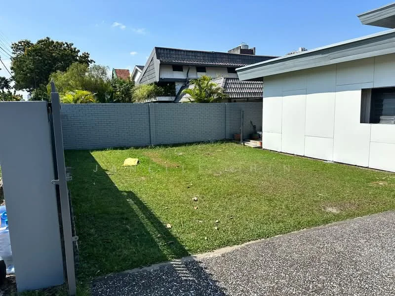 Exterior type: detached bungalow; features: manicured lawn, concrete pathway, fenced perimeter, single-storey building, grey brick wall, clear blue sky, surrounded by residential buildings; style: modern.