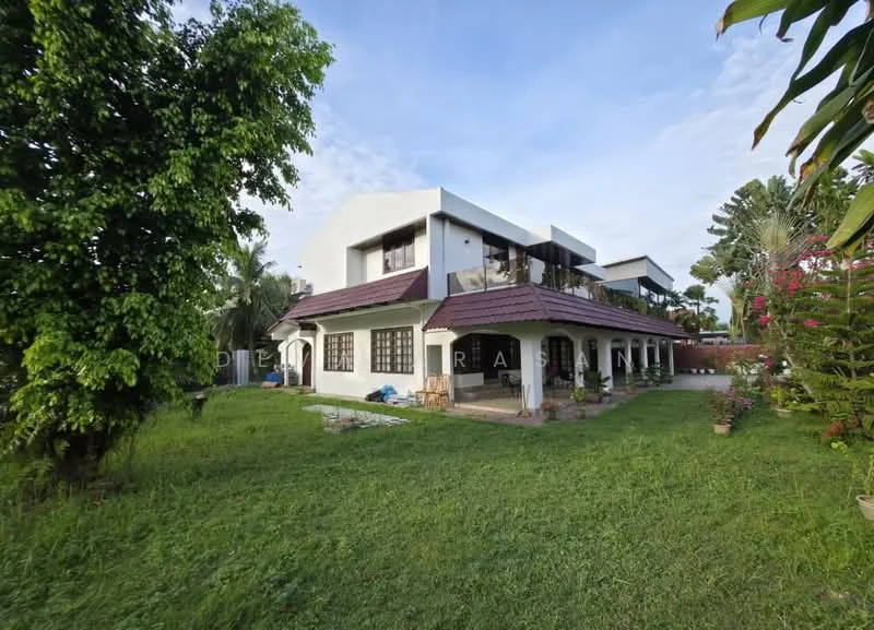 Exterior type: detached bungalow; features: two-storey building, sloping tiled roof, white painted facade, large windows, manicured lawn, surrounded by greenery, patio area, garden with tropical plants, driveway, outdoor seating area; style: modern.