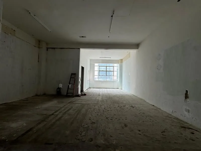Room features: bare concrete flooring, white painted walls, large window providing natural light, high ceiling, exposed ceiling lights, open layout, no visible furnishings, ladder in the corner; style: minimalist.
