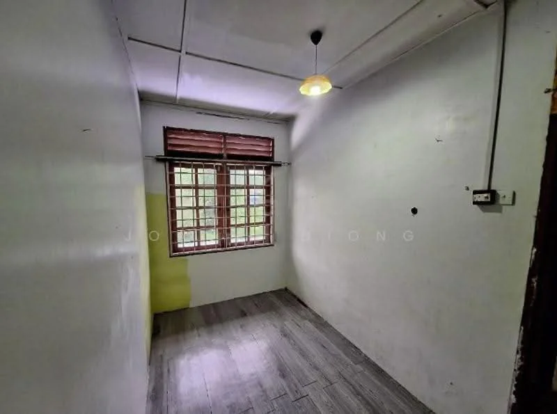 Room features: white painted walls, yellow accent wall, laminate flooring, single light fixture, window with wooden grille, no visible furniture.