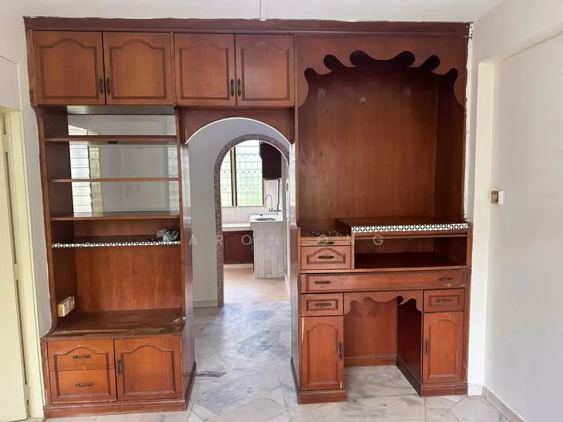 Room features: wooden cabinetry, built-in shelves, arched opening, decorative trim, marble flooring, light-colored walls, window with natural light, counter space; style: traditional.