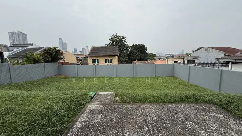 Exterior features: fenced yard, overgrown grass, concrete patio, city skyline in background, surrounded by residential buildings, grey painted boundary wall.