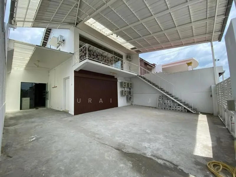 Exterior type: detached bungalow; features: open-air parking area, concrete flooring, metal staircase, exposed air conditioning units, covered terrace, white painted walls, balcony with decorative railing, roof overhang, manicured landscaping, surrounded by walls for privacy; style: modern.