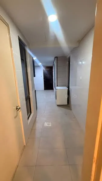 Room features: grey tiled flooring, white painted walls, ceiling lights, doorway leading to another room, windows along one side, laundry area with washing machine, narrow hallway layout.