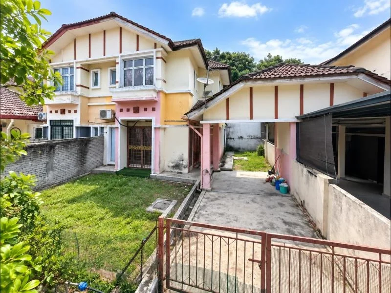 Exterior type: linked terrace house; features: double-storey, cream painted facade, pink and yellow exterior walls, brown tiled pitched roof, projecting balconies, fronts a quiet residential street, manicured lawn, stone-paved walkway, driveway with concrete paving, car porch with awning, gated entry, perimeter wall, surrounded by mature greenery; style: traditional.