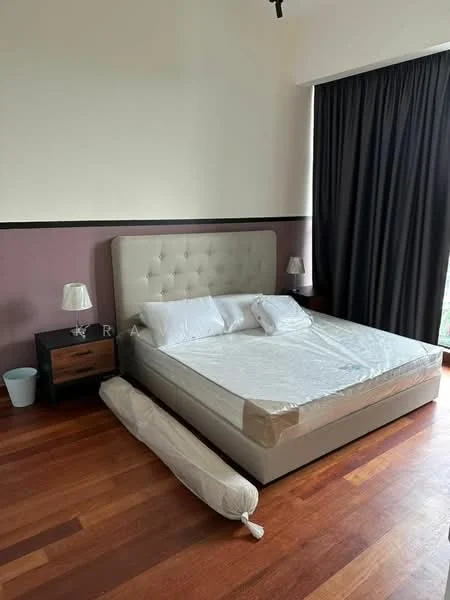 Bedroom features: king-size bed with upholstered headboard, wooden flooring, dark curtains, nightstand with lamp, decorative wall with two-tone paint, large window with view, unmade bed with bedding, floor space with rolled-up mattress; style: modern.