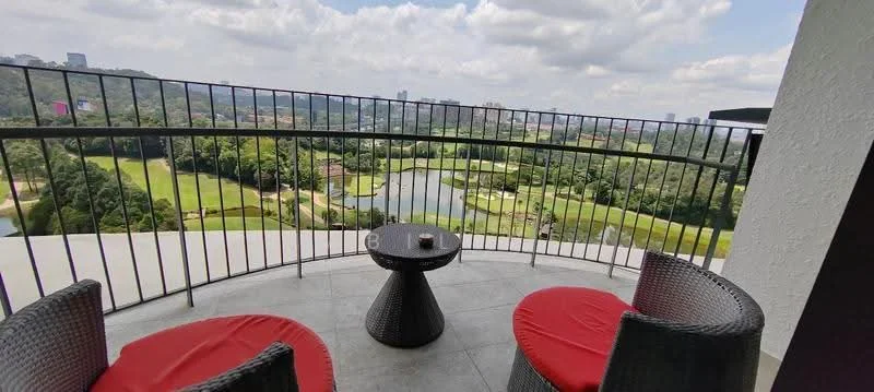 Balcony features: outdoor seating with two round chairs, red cushions on chairs, small round table, metal railing, tile flooring, view of golf course, view of water body, surrounded by greenery, skyline in background; style: modern; view: golf course.