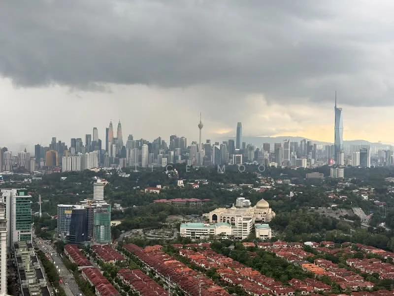 Exterior type: high-rise condominium; features: city skyline view, surrounded by greenery, urban landscape, high-rise buildings, prominent landmarks visible, cloudy sky, mixed-use development, red-tiled rooftops in foreground; style: modern.