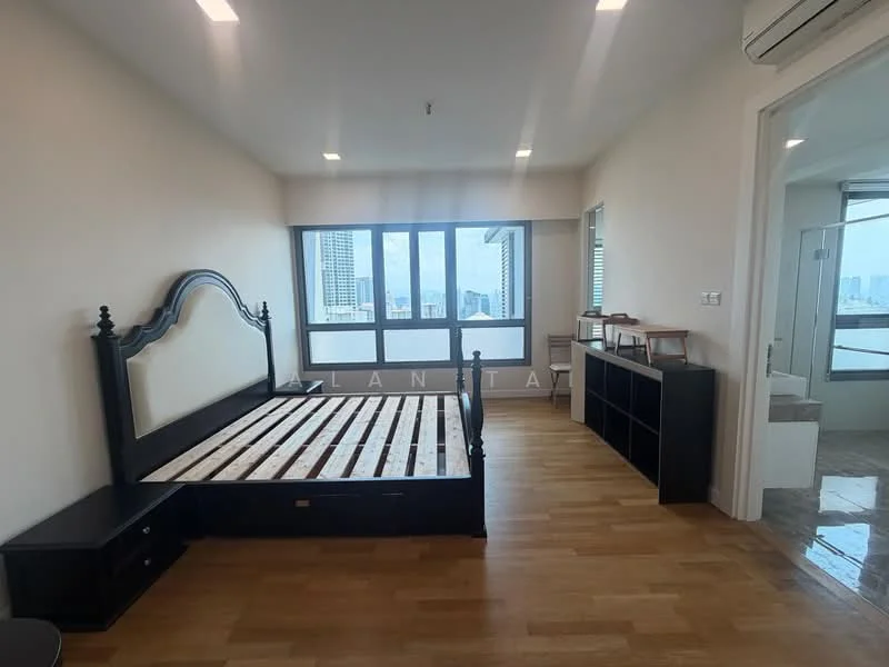Bedroom features: wooden flooring, white painted walls, floor-to-ceiling windows, black wooden bed frame, empty mattress base, black bedside table, built-in wardrobe, natural light from windows, city view from windows, air conditioning unit; style: modern; view: city.