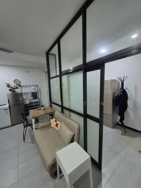 Room features: grey tiled flooring, white painted walls, glass partition wall, sofa with beige upholstery, small white side table, dining table with chairs, refrigerator, clothes rack, coat rack, overhead lighting; style: modern.