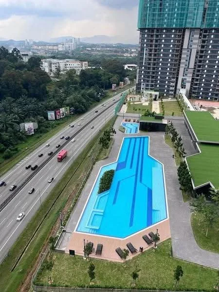 Exterior type: high-rise condominium; features: infinity pool, pool deck with loungers, landscaped garden area, manicured lawn, surrounded by greenery, adjacent to highway, modern architectural design, multiple levels of landscaping; style: modern.