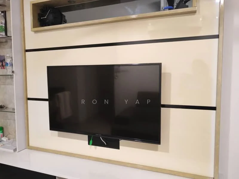 Room features: wall-mounted TV, cream painted wall, black accent stripes, built-in shelving, glass display cabinet, decorative items on shelves; style: modern.
