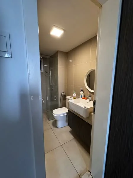Bathroom features: white ceramic toilet, single-sink vanity with wood cabinet, round mirror, glass shower enclosure, chrome shower head, grey tiled walls, light grey floor tiles, recessed ceiling lights; style: modern.