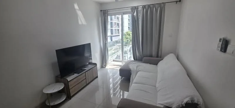 Living features: 3-seater fabric sofa in light grey, white throw blanket on sofa, wooden TV console, flat-screen TV, floor-to-ceiling sliding glass door, curtains in grey, white painted walls, glossy tile flooring, natural light from window, small round side table; style: modern; view: garden.