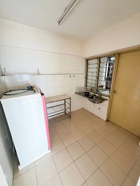 Kitchen features: white tiled walls, cream tiled flooring, single-bowl stainless-steel sink, chrome faucet, white fridge, metal shelving unit, window with metal grilles, door leading to another room.