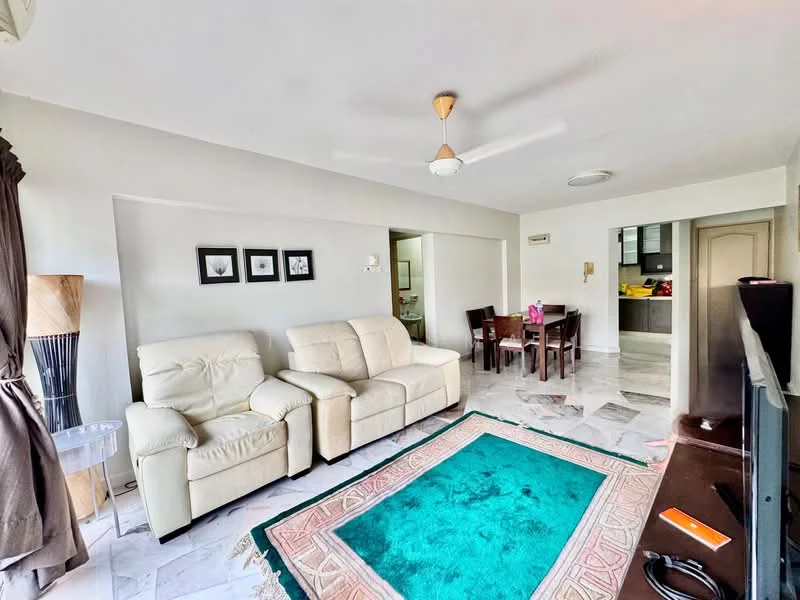 Living features: 3-seater fabric sofa in cream, ceiling fan with light, marble flooring, area rug with geometric pattern in teal and pink, wall-mounted TV, decorative wall art in frames, dining table with chairs visible in background, open layout to kitchen, natural light from windows, light-colored painted walls; style: modern.