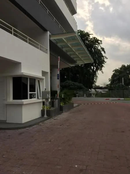 Exterior type: low-rise apartment block; features: white painted facade, glass awning, paved driveway, landscaped garden area, security guard house, parking access, surrounded by greenery; style: modern.