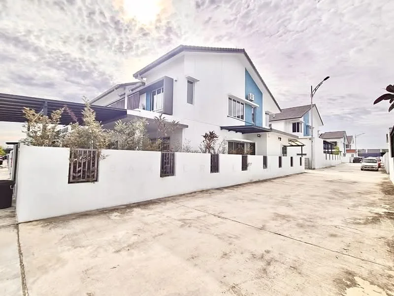 Exterior type: semi-detached house; features: white painted facade, blue accent wall, flat roof, driveway with interlocking pavers, manicured landscaping with shrubs, car porch, windows with grilles, air conditioning unit visible, surrounded by residential buildings; style: modern.