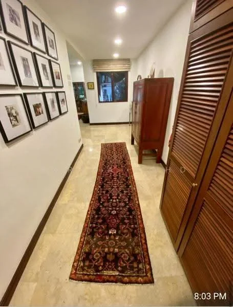 Hallway features: white painted walls, marble flooring, recessed downlights, framed artwork on walls, wooden cabinet, built-in wardrobe with louvered doors, decorative runner rug, window with blinds; style: modern.