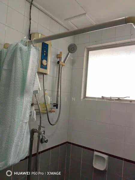 Bathroom features: white tiled walls, grey tiled flooring, shower area with glass partition, overhead shower with adjustable height, handheld shower head, water heater unit, toilet, window for natural light; style: modern.