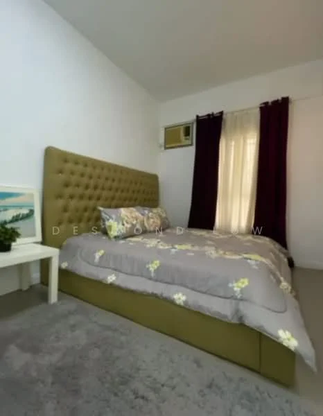 Bedroom features: queen-size bed with upholstered headboard, grey floral bedding, white painted walls, carpet flooring, floor-to-ceiling window with sheer curtains, dark purple curtains, small bedside table, decorative plant on bedside table, wall-mounted air conditioning unit; style: modern.