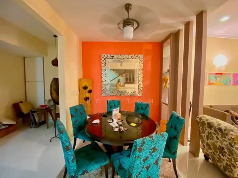 Dining features: round dining table, upholstered dining chairs with blue floral pattern, decorative mirror on wall, orange accent wall, chandelier with glass shade, ceramic tile flooring, wall-mounted artwork, open layout to adjacent living area; style: modern. Room features: cream painted walls, wooden furniture, decorative items on shelves.