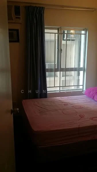 Bedroom features: single bed with pink bedsheet, floor-to-ceiling window, curtains in dark blue, wall-mounted air conditioning unit, wooden flooring, light-colored walls, bedside table, decorative wall frame.