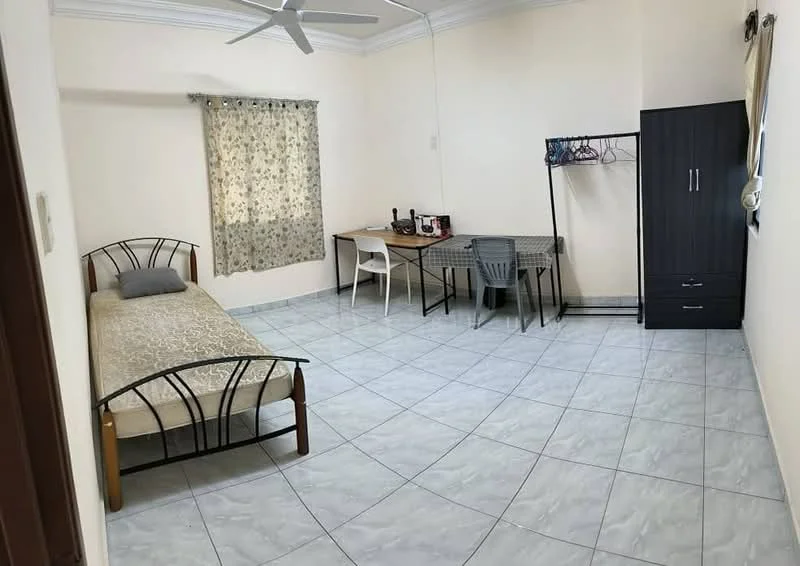 Bedroom features: single bed with metal frame, grey bedding, white walls, ceiling fan, window with sheer curtains, tile flooring, study desk with chair, black wardrobe, clothes rack, decorative wall clock; style: minimalist.