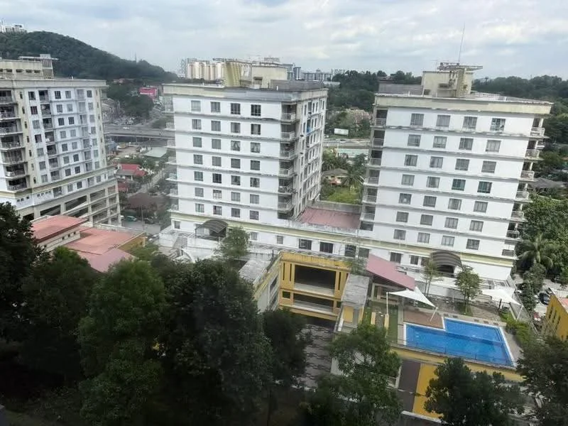 Exterior type: mid-rise condominium; features: white painted facade, flat roof, approximately 5-storey, infinity pool, landscaped garden, manicured lawn, surrounded by mature greenery, parking area visible; style: modern.