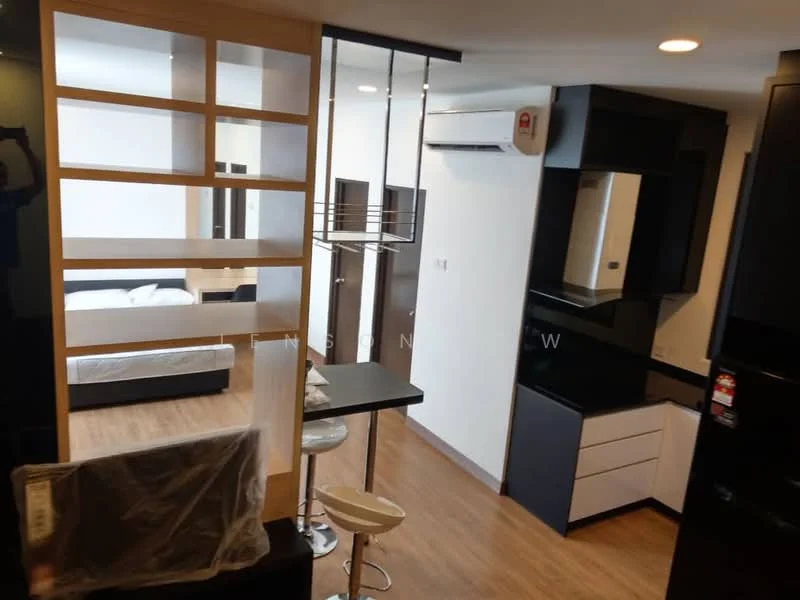 Living features: wood laminate flooring, black kitchen cabinetry, white lower cabinets, black countertop, stainless-steel sink, built-in oven, refrigerator, air conditioning unit, bar table with stools, partition shelving, wall-mounted mirror, bed visible in background; style: modern.