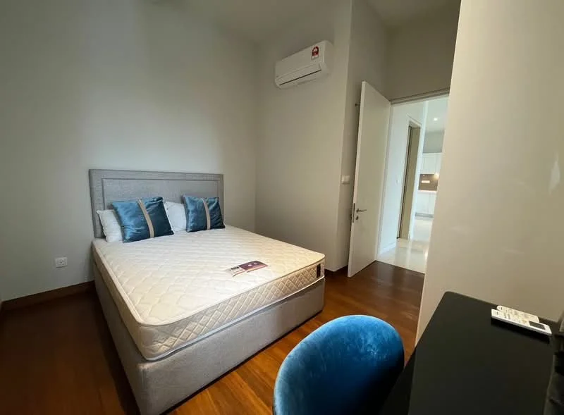 Bedroom features: queen-size bed, upholstered headboard, two decorative pillows in blue, wood flooring, wall-mounted split AC, white painted walls, door leading to another room, desk with black surface, blue chair; style: modern.