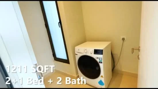 Laundry features: front-load washing machine in white, cream painted walls, light beige tile flooring, window with black frame, plumbing connection visible, electrical outlet visible.