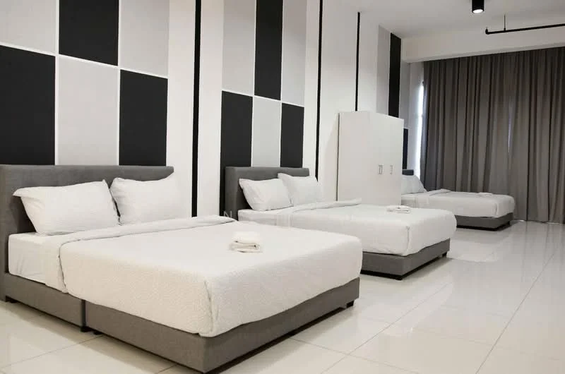 Bedroom features: 4 single beds with grey upholstered bases, white bedding, grey accent wall with geometric pattern, white painted walls, large windows with grey curtains, polished tile flooring, ceiling light fixture, built-in wardrobe; style: modern.