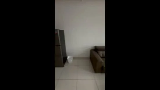 Room features: grey leather sofa, stainless-steel fridge, white walls, glossy tile flooring; style: modern.