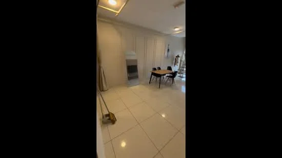 Dining features: white painted walls, glossy white tile flooring, dining table with four black chairs, built-in cabinetry, recessed downlights, floor-to-ceiling mirror, decorative wall art, clean minimalist decor; style: modern.