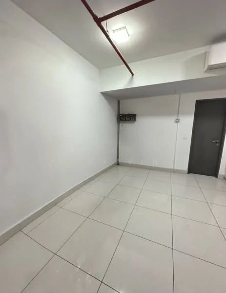 Room features: white painted walls, glossy ceramic tile flooring, ceiling light fixture, air conditioning unit, grey door, exposed ceiling pipes, electrical panel on wall.