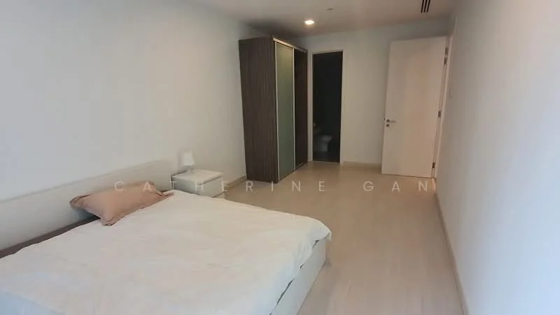 Bedroom features: queen-size bed, light bedding, nightstand, table lamp, built-in wardrobe, white painted walls, light wood flooring, sliding door to bathroom, minimalist decor; style: modern.