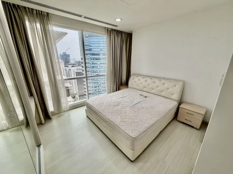 Bedroom features: queen-size bed, upholstered headboard, nightstand, floor-to-ceiling windows, sheer curtains, city view, light wood flooring, built-in wardrobe with mirrored doors; style: modern; view: city.