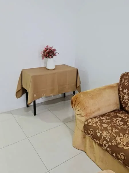 Room features: cream painted walls, light-colored tiled flooring, brown fabric sofa with floral pattern, small table with brown tablecloth, white vase with flowers; style: modern.