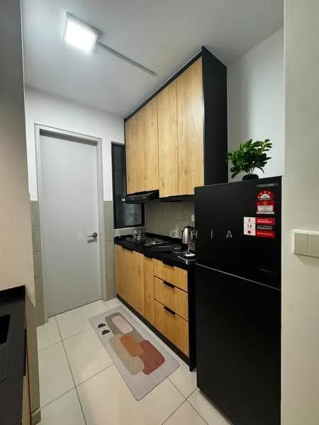 Kitchen features: black cabinetry, wood grain cabinetry, black countertop, stainless-steel sink, chrome pull-down faucet, built-in gas stove, black range hood, black refrigerator, white tiled walls, cream tiled flooring, kitchen mat, wall-mounted plant, door to hallway; style: modern.