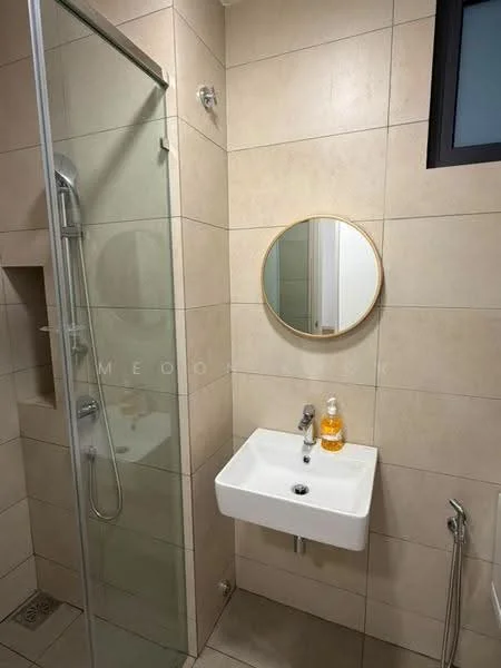 Bathroom features: glass shower enclosure, rain shower head, wall-mounted shower faucet, round mirror with gold frame, white wall-mounted sink, chrome sink faucet, beige tiled walls, tile flooring, drain in floor, small window for natural light; style: modern.