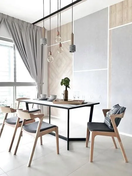Dining features: rectangular dining table with black metal frame, 4 wooden dining chairs with grey upholstery, hanging pendant lights with glass shades, grey curtains, light-colored wall with wood paneling, white tiled flooring, decorative plant in a pot, glassware on the table; style: modern; view: city.