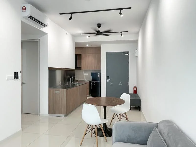 Living features: grey fabric sofa, round wooden dining table, white dining chairs, wall-mounted split AC, 5-blade ceiling fan with light, white painted walls, glossy tile flooring, kitchenette with wooden cabinetry, stainless-steel sink, built-in oven, refrigerator, door to hallway, fire extinguisher, window with natural light; style: modern.