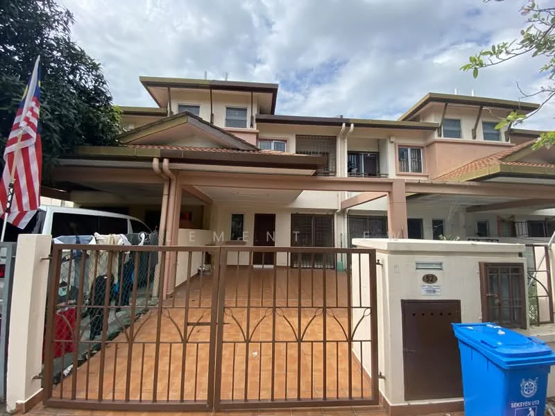 Exterior type: linked terrace house; features: two-storey building, cream painted facade, recessed balconies, gated entrance, paved driveway, manicured lawn, flagpole with American flag, visible car parked in driveway, blue recycling bin, security gate, overhanging eaves, roof with tiles; style: modern.