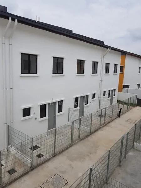 Exterior type: linked terrace house; features: white painted facade, two-storey building, multiple windows, fenced perimeter, concrete pathway, visible drainage system, grey roof, minimalist design, adjacent buildings, urban setting; style: modern.