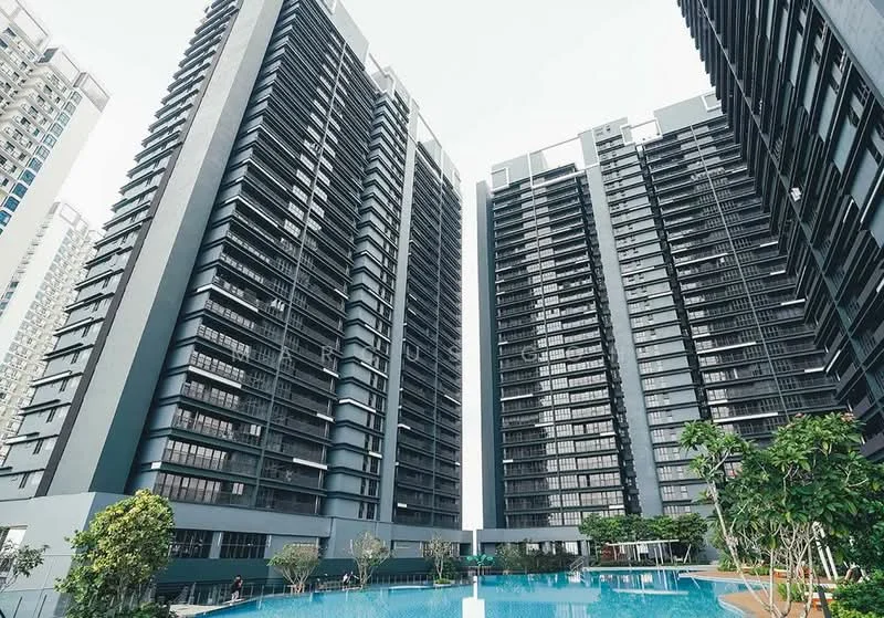 Exterior type: high-rise condominium; features: glass curtain wall, grey painted facade, approximately 20-storey high-rise, infinity pool, landscaped garden, manicured lawn, mature trees, pool deck with loungers; style: modern.