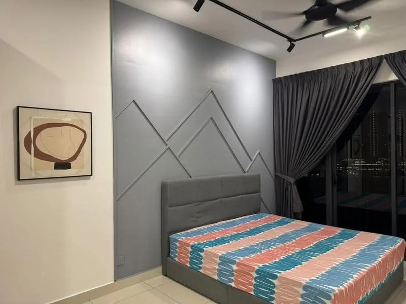 Bedroom features: grey upholstered bed frame, queen-size bed, striped bedspread in pink and blue, decorative wall with geometric patterns in grey, white painted walls, floor-to-ceiling windows, dark grey curtains, ceiling fan, light-colored tile flooring, framed artwork on wall; style: modern; view: city.