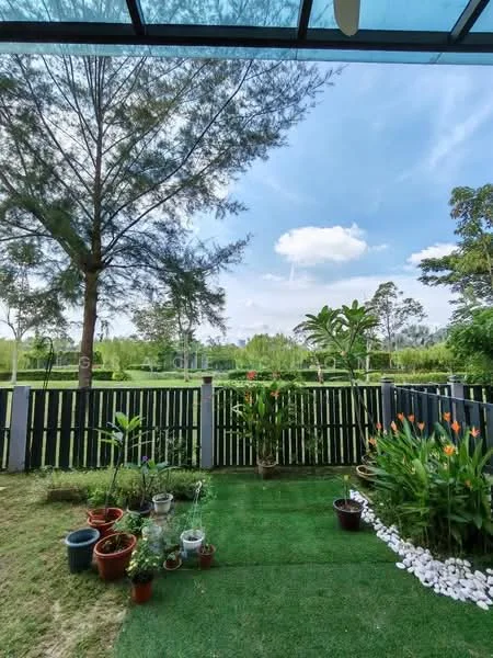 Exterior type: landscape garden; features: manicured lawn, decorative stone pathway, flower beds with various plants, fenced garden area, trees providing shade, green grass, potted plants, open sky view; style: tropical-modern.