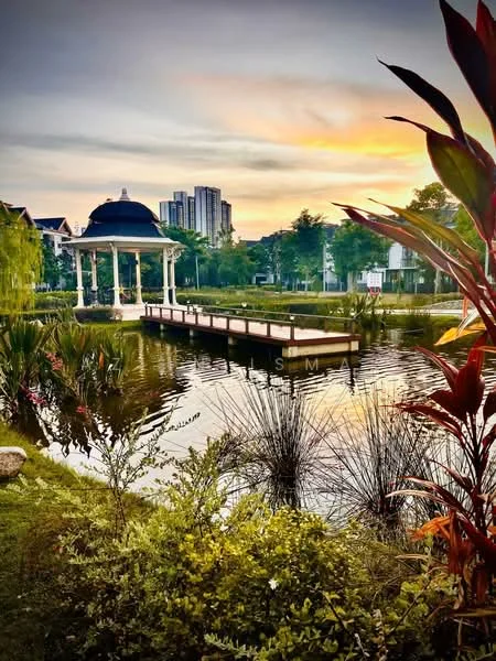 Exterior type: landscape garden; features: gazebo with dome roof, wooden walkway over water, manicured lawn, tropical landscaping with palm trees, water body with reflections, surrounding greenery, city skyline in background, sunset sky with orange and purple hues; style: tropical-modern.